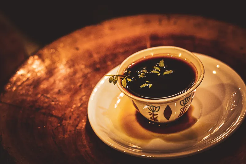 A cup of Ethiopian coffee with rue leaves at a coffee ceremony in Addis Ababa